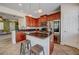 Open kitchen featuring a central island, stainless steel appliances, and wood cabinetry at 7348 Yoder St, Windermere, FL 34786
