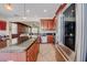Open kitchen featuring granite countertops, stainless steel appliances, and wood cabinetry at 7348 Yoder St, Windermere, FL 34786