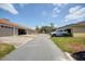 Community street with attached garages and a silver SUV parked in one of the driveways at 7348 Yoder St, Windermere, FL 34786