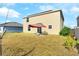 Back exterior view of a two-story home with a spacious backyard at 740 Simone Ct, Haines City, FL 33844