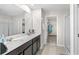 Bathroom features dual sinks, large mirror, and walk in closet access at 740 Simone Ct, Haines City, FL 33844
