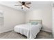 Cozy bedroom featuring neutral walls, plush carpeting, and a ceiling fan at 740 Simone Ct, Haines City, FL 33844