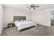 Bedroom with comfortable carpeting, ceiling fan, and stylish headboard at 740 Simone Ct, Haines City, FL 33844