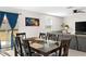 Bright dining area adjacent to the living room, featuring sliding glass doors and seating for six at 740 Simone Ct, Haines City, FL 33844