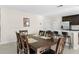 Inviting dining area adjacent to kitchen, featuring a large wooden table with seating for eight at 740 Simone Ct, Haines City, FL 33844
