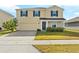 Charming two-story home featuring a two-car garage, well-maintained lawn, and inviting front porch at 740 Simone Ct, Haines City, FL 33844