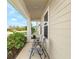 Inviting front porch featuring two chairs for relaxing, and lush landscaping at 740 Simone Ct, Haines City, FL 33844