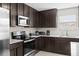 Close up of kitchen appliances and counter space, including stainless steel appliances and dark wood cabinetry at 740 Simone Ct, Haines City, FL 33844