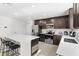 Spacious kitchen showcasing stainless steel appliances, ample cabinet space, and a convenient breakfast bar at 740 Simone Ct, Haines City, FL 33844