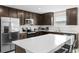 Well-equipped kitchen featuring stainless steel appliances, quartz countertops, and barstool seating at the island at 740 Simone Ct, Haines City, FL 33844