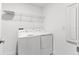 Bright laundry room with a washer, dryer, and overhead wire shelf at 740 Simone Ct, Haines City, FL 33844