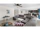 Open-concept living room flows into the kitchen and dining area, featuring a large sectional sofa at 740 Simone Ct, Haines City, FL 33844