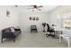 Well-lit room featuring neutral flooring, ceiling fan, comfortable seating, and dedicated workspace at 740 Simone Ct, Haines City, FL 33844
