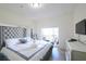 Bright bedroom features large bed, TV, and screened-in porch access at 7505 Pellham Way, Kissimmee, FL 34747