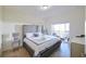 Bedroom features a luxurious bed with patio access at 7505 Pellham Way, Kissimmee, FL 34747