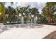 Community splash pad with a central fountain surrounded by palm trees and a playground at 7505 Pellham Way, Kissimmee, FL 34747
