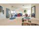 Bright open-concept living area with modern decor, including a blue sofa and dining table at 7505 Pellham Way, Kissimmee, FL 34747