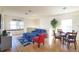Bright and airy living room with a comfortable sofa, dining table, and a large window at 7505 Pellham Way, Kissimmee, FL 34747