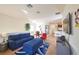 Open-concept living room with modern furnishings and decor, adjacent to the dining area and kitchen at 7505 Pellham Way, Kissimmee, FL 34747