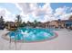 Resort-style pool with lounge chairs, palm trees, and clubhouse for relaxation and enjoyment at 7505 Pellham Way, Kissimmee, FL 34747