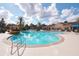 Resort-style pool with lounge chairs, palm trees, and clubhouse for relaxation and enjoyment at 7505 Pellham Way, Kissimmee, FL 34747
