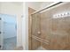 Walk-in shower features glass door and tiled surround at 7505 Pellham Way, Kissimmee, FL 34747