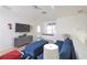 Upstairs living area with comfortable seating, a TV, and a large window for natural light at 7505 Pellham Way, Kissimmee, FL 34747