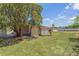 Spacious backyard featuring a shed and mature trees offering shade and privacy at 7700 Grevillea Dr, Orlando, FL 32822