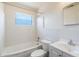 Clean bathroom featuring white tiled walls, a tub, and a sleek vanity at 7700 Grevillea Dr, Orlando, FL 32822