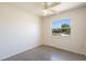 Bright bedroom with ceiling fan and a window offering a pleasant outdoor view at 7700 Grevillea Dr, Orlando, FL 32822