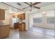 Functional kitchen with wooden cabinets and a sliding door to the lanai at 7700 Grevillea Dr, Orlando, FL 32822