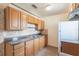 Well-lit kitchen with wood cabinets, tile backsplash, and essential appliances at 7700 Grevillea Dr, Orlando, FL 32822