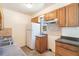 Efficient kitchen with wood cabinets, tiled backsplash, and ample countertop space at 7700 Grevillea Dr, Orlando, FL 32822
