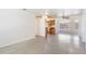 Spacious living area with terrazzo flooring, connecting to the kitchen at 7700 Grevillea Dr, Orlando, FL 32822