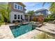 Back exterior of home showcases the pool and patio area with a manicured lawn at 8263 Bellow St, Orlando, FL 32827
