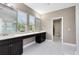 Bathroom with double sinks, neutral walls, and views to the outside at 8263 Bellow St, Orlando, FL 32827