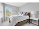Bright bedroom featuring a bed, window, and nightstand at 8263 Bellow St, Orlando, FL 32827