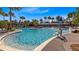 Resort-style community pool featuring lounge chairs, water features and palm tree landscaping at 8263 Bellow St, Orlando, FL 32827