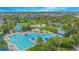 Aerial view of community pool, lounge chairs, mature landscaping, and other community amenities at 8263 Bellow St, Orlando, FL 32827