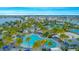 Aerial view of the community pool with palm trees, lounge chairs, and beach volleyball court at 8263 Bellow St, Orlando, FL 32827