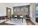 Dining room with grey accent wall, large framed mirror, table with seating for six and large windows at 8263 Bellow St, Orlando, FL 32827