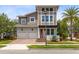 Contemporary two-story home with a red door, a two-car garage, and a well-manicured lawn at 8263 Bellow St, Orlando, FL 32827