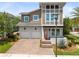 Exterior elevation featuring a two-story home with a two-car garage, well-manicured lawn, and palm trees at 8263 Bellow St, Orlando, FL 32827