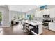 Open-concept kitchen flows into the living area, featuring stainless steel appliances and a large island at 8263 Bellow St, Orlando, FL 32827