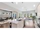Open-concept kitchen features a large island with marble countertop, stainless steel appliances, and ample cabinet space at 8263 Bellow St, Orlando, FL 32827