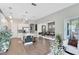 Open-concept kitchen and dining area features hardwood floors, kitchen island, white cabinets and stainless appliances at 8263 Bellow St, Orlando, FL 32827