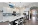 Modern kitchen featuring stainless steel appliances, a large island, and white cabinetry at 8263 Bellow St, Orlando, FL 32827