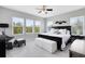 Main bedroom features large windows, neutral paint, ceiling fan and furnishings at 8263 Bellow St, Orlando, FL 32827