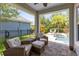 View from the covered patio showcases the pool and the seating with comfortable cushions at 8263 Bellow St, Orlando, FL 32827