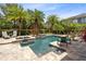 Beautiful pool and patio area with in-ground hot tub and mature landscaping for privacy at 8263 Bellow St, Orlando, FL 32827